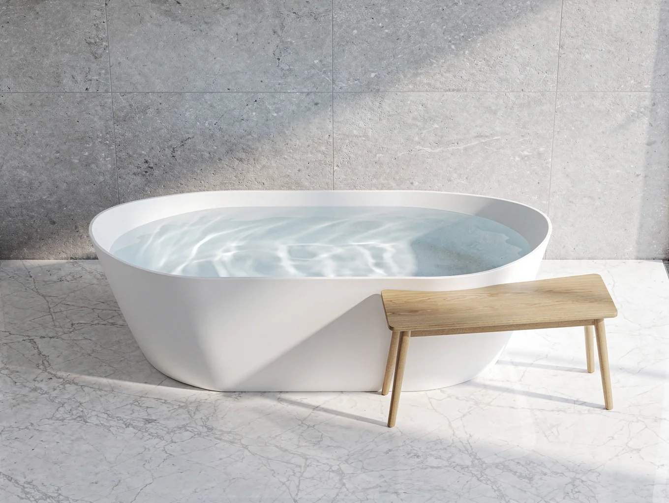 Sculptural freestanding soaking tub in front of arched architectural niche
