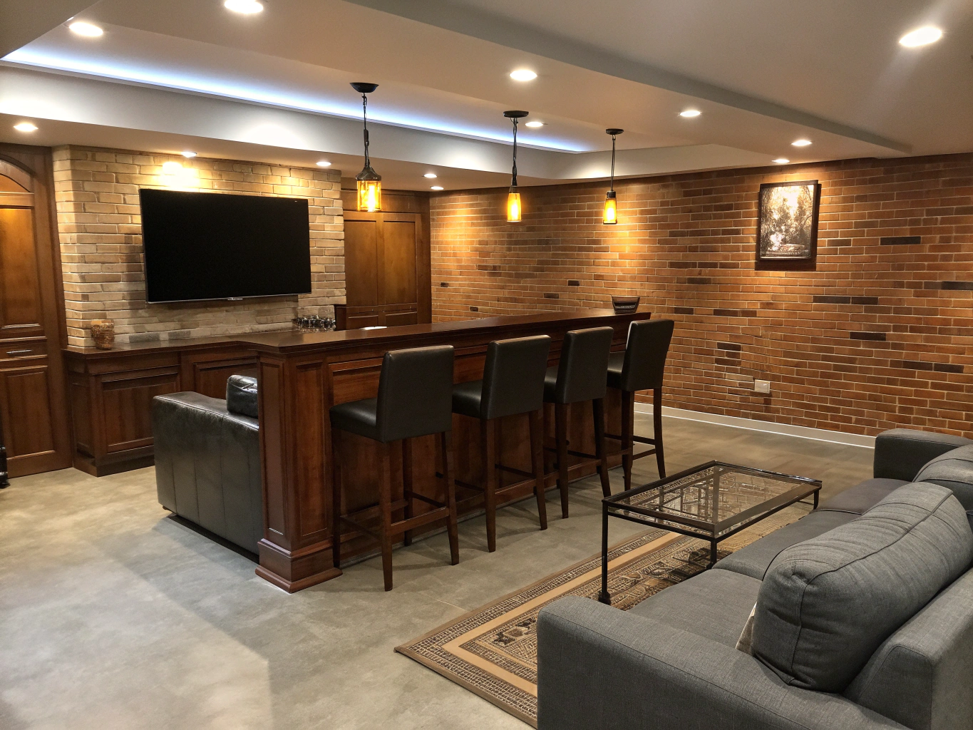 Finished modern basement entertainment lounge with wet bar and seating